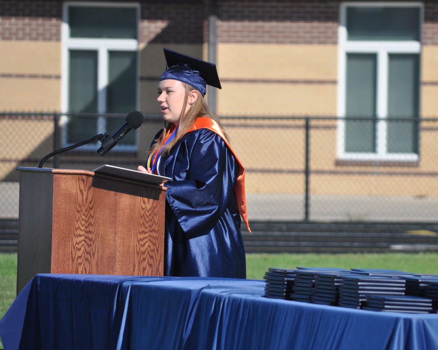 Gracie Chapman delivers her portion of the valedictory address Saturday during North Montgomery High School's graduation ceremony at Charger Field. Kade Kobel, Benjamin Lovold and Madison Moseley gave the rest of the address.